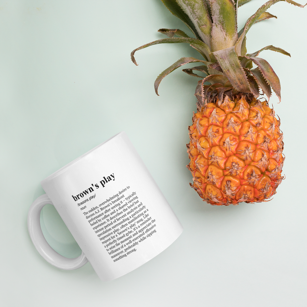 Glossy white ceramic coffee mug, football.